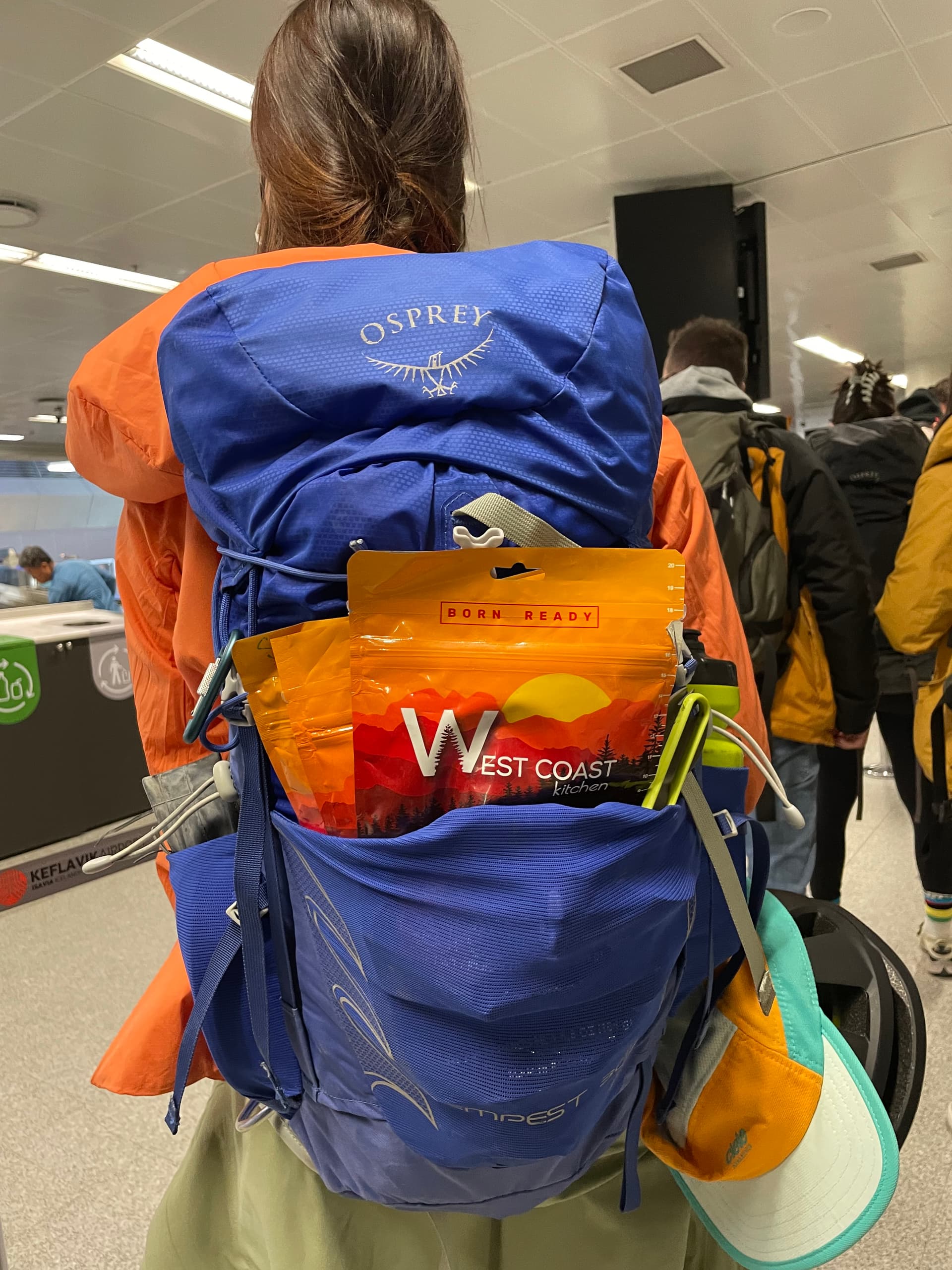 WCK pouch clipped to an Osprey backpack at the airport before departure
